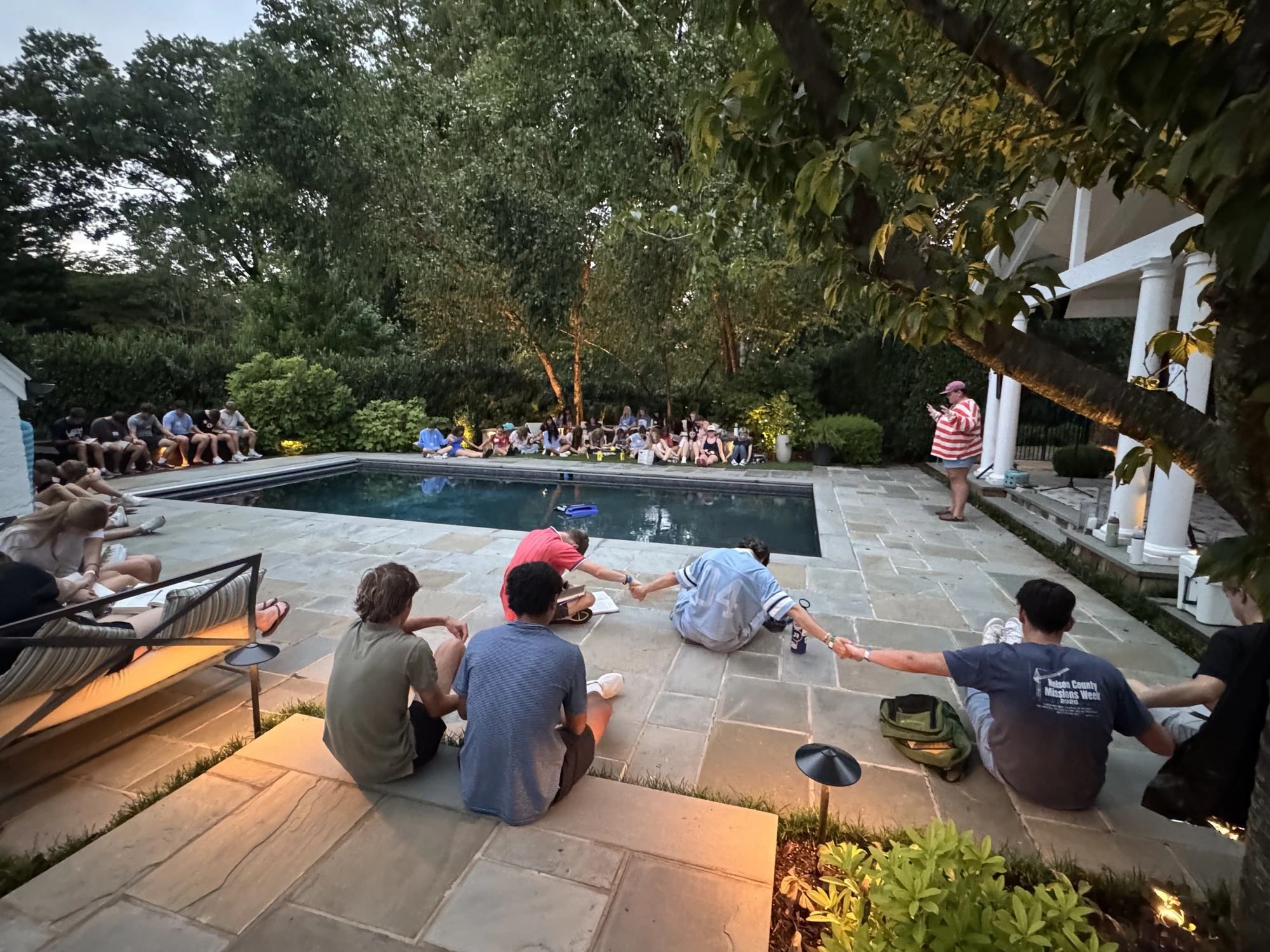 Students gathered around the pool in prayer